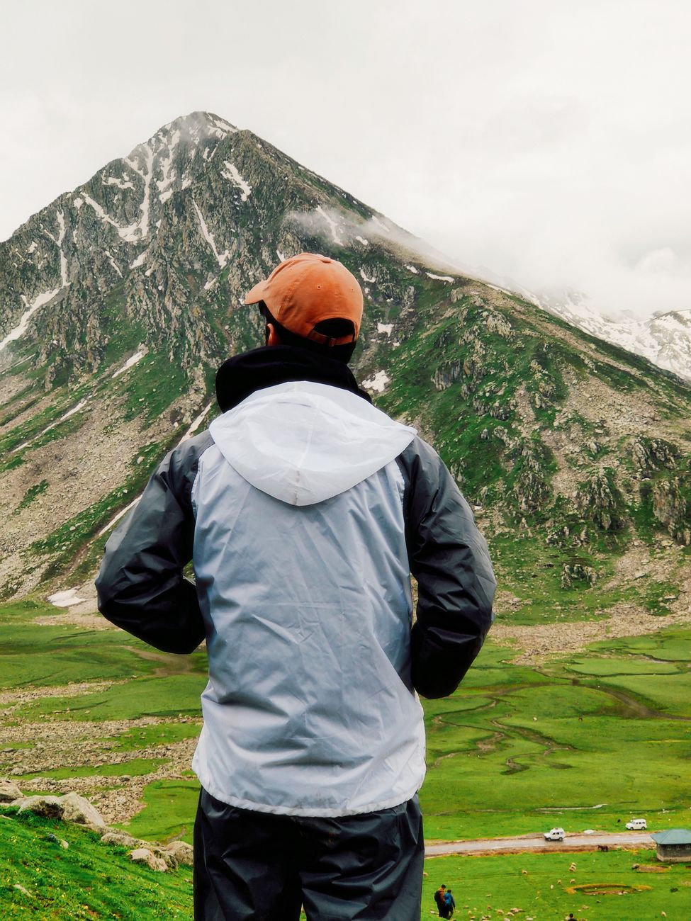 Traveler looking out toward panoramic alpine horizon